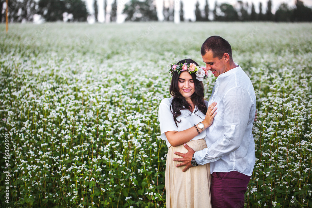 pretty pregnant with her husband in the field pretty pregnant with her husband in the field