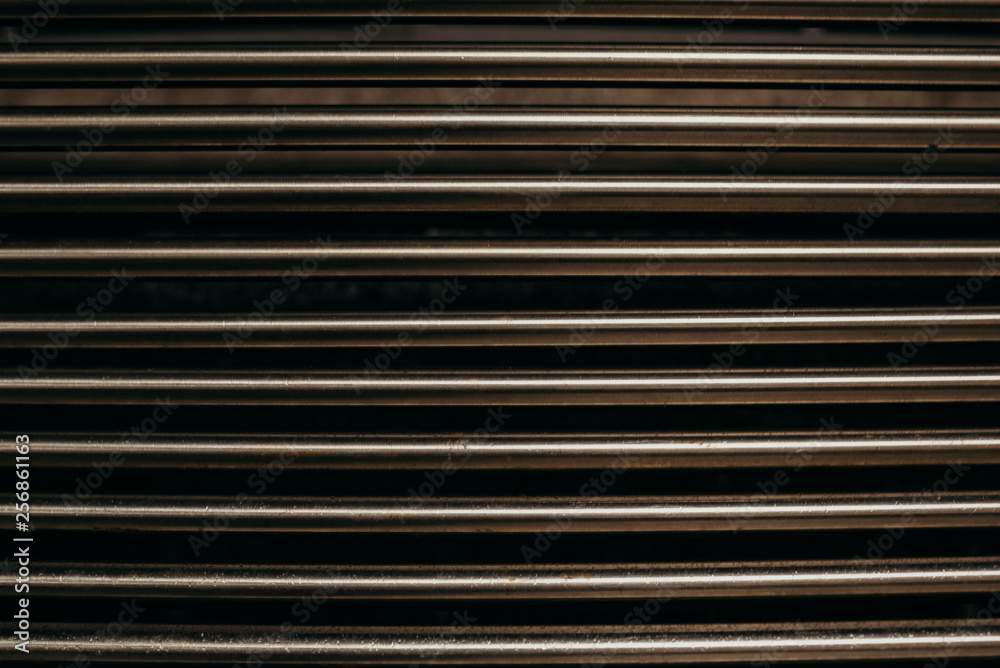 Stainless steel wall background. Metallic sticks. Reflection of the metallic color. Сlose up shot. Noise and gain Stainless steel wall background. Metallic sticks. Reflection of the metallic color. Сlose up shot. Noise and gain