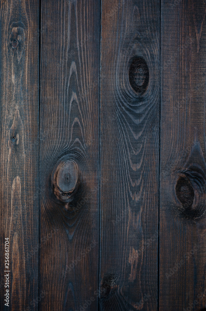 Dark wooden background made of a wide board. Dark wooden background made of a wide board.