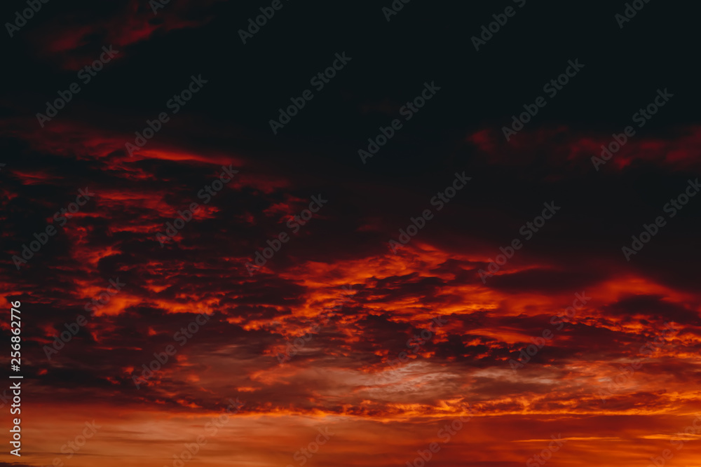 Fiery red blood vampire dawn. Amazing warm dramatic fire cloudy sky. Vivid orange sunlight. Atmospheric background of sunrise in overcast weather. Hard cloudiness. Storm clouds warning. Copy space. Fiery red blood vampire dawn. Amazing warm dramatic fire cloudy sky. Vivid orange sunlight. Atmospheric background of sunrise in overcast weather. Hard cloudiness. Storm clouds warning. Copy space.