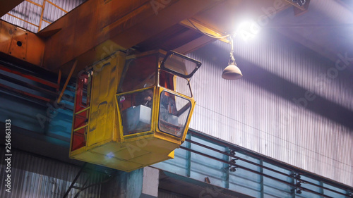Industrial concept. A man controls the big industrial crane