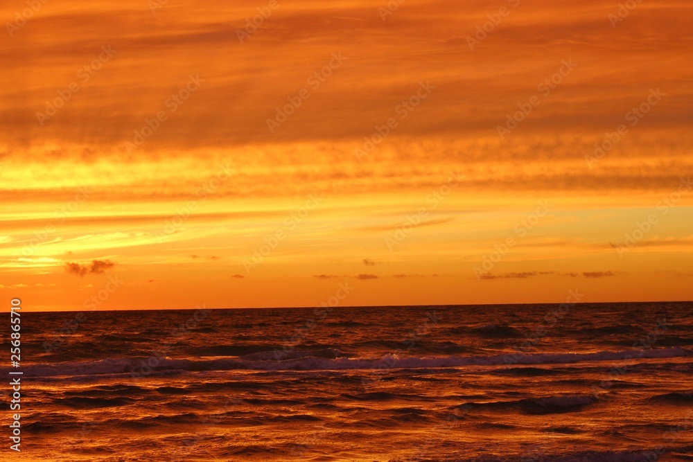 Magnificent sunset on the beach of Lokken, North Jutland, Denmark, Europe. View of the North Sea.