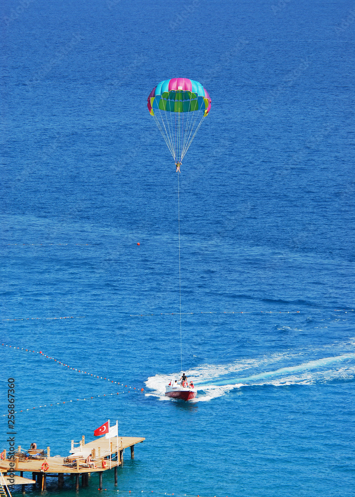 Fly a parachute over the sea, paraglider flying over the sea Fly a parachute over the sea, paraglider flying over the sea