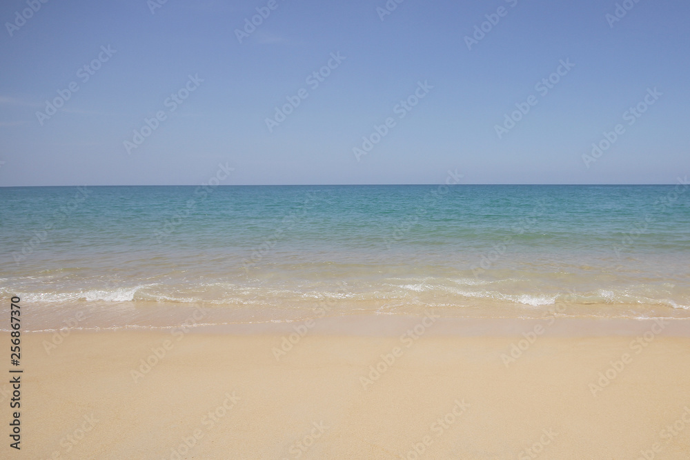 Idyllic crystal beach and seawater in front of luxury hotel, attractive clear sea, nature coastline backgrounds during holidays sunbathing, wave from clear blue green sea and fine sand