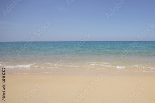 Idyllic crystal beach and seawater in front of luxury hotel, attractive clear sea, nature coastline backgrounds during holidays sunbathing, wave from clear blue green sea and fine sand