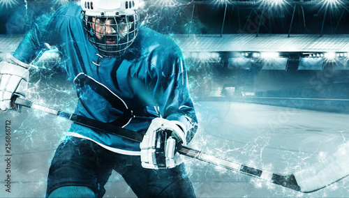 Canvas Print Ice Hockey player athlete in the helmet and gloves on stadium with stick