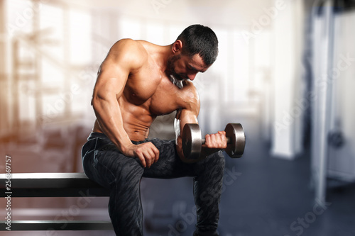 muscular young man lifting weights in epic gym 