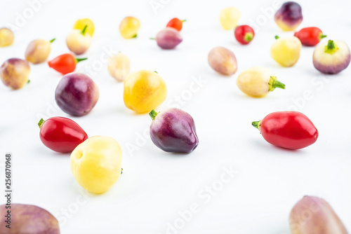 Fresh colorful peppers on white background