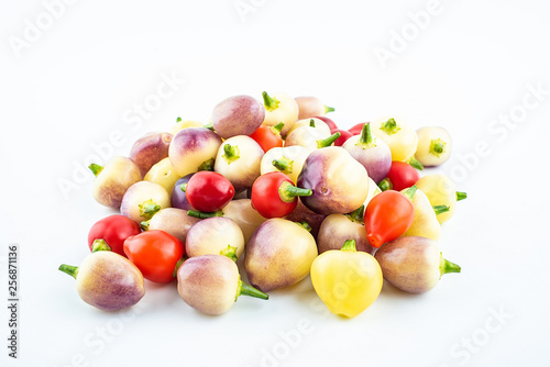 Bunch of fresh colorful peppers on white background