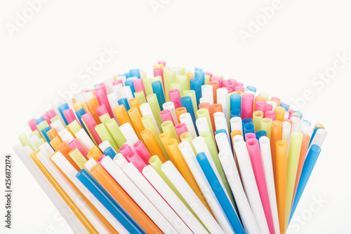 selective focus of colorful and bright plastic straws isolated on white with copy space