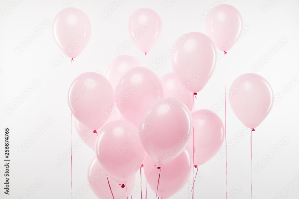 background with bundle of decorative pink air balloons on white