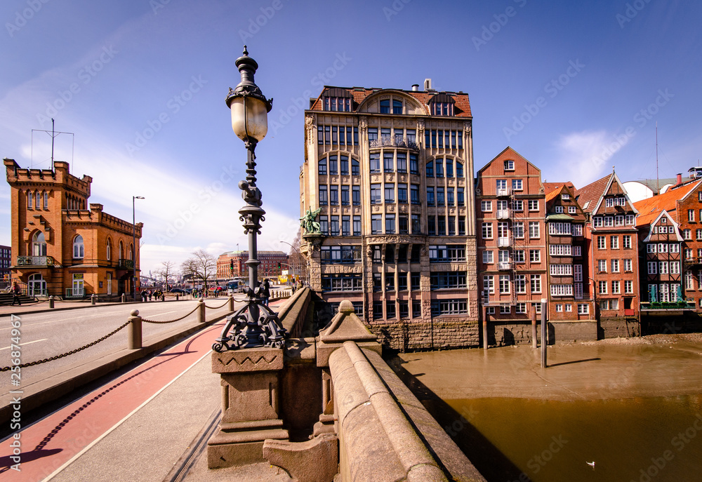 Hamburg at nikolaifleet with low water, in the foreground old street lamp