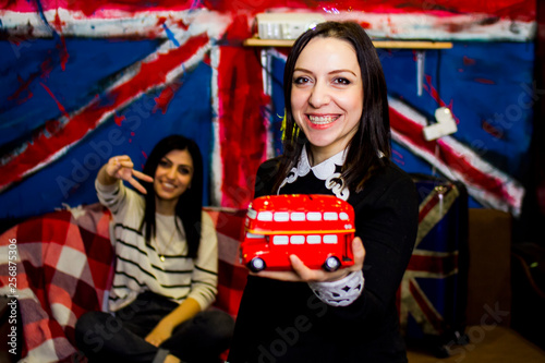 English teacher with a red bus in hand close-up