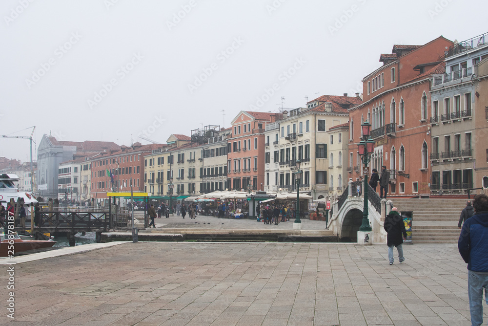 Venice / Italy 19 february 2019 :Snapshot of the river the people and the houses by the canal,traditional building and the bridge that connects the street to the other side