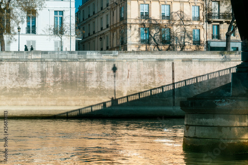 Parisian bridge and building seen from the Seine photo