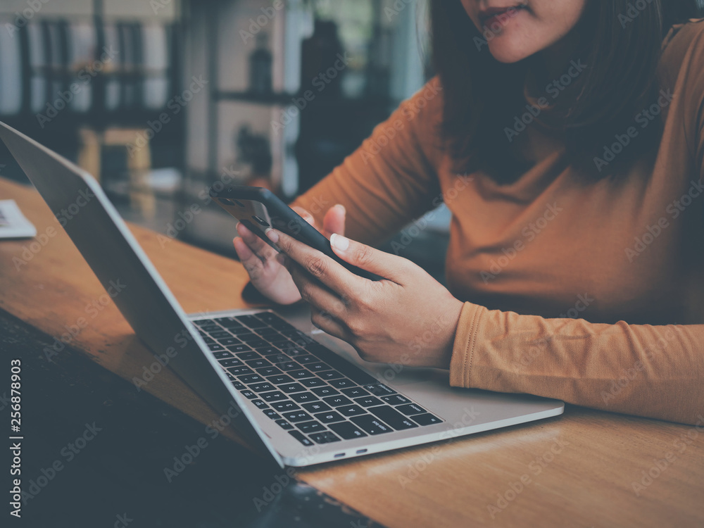 Fototapeta premium Asian woman using laptop computer in coffee shop cafe