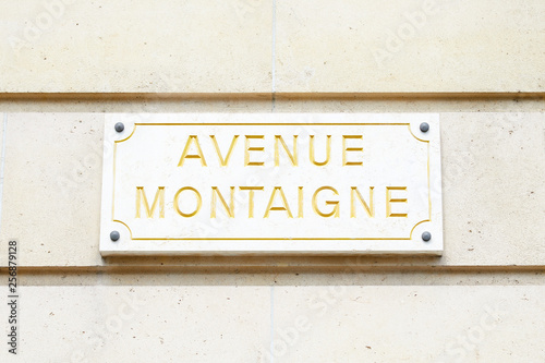Famous Avenue Montaigne street sign in golden letters in Paris, France