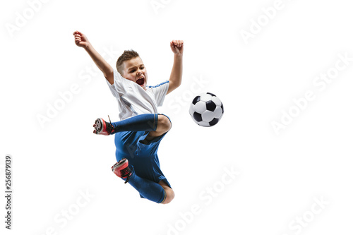 Young boy kicks the soccer ball. Isolated photo on white background. Football player in motion at studio. Fit jumping boy in action, jump, movement at game. © master1305