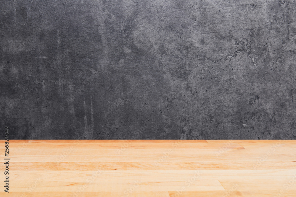 Empty wooden table over black concrete background. Copy space for text, design or product display montage.