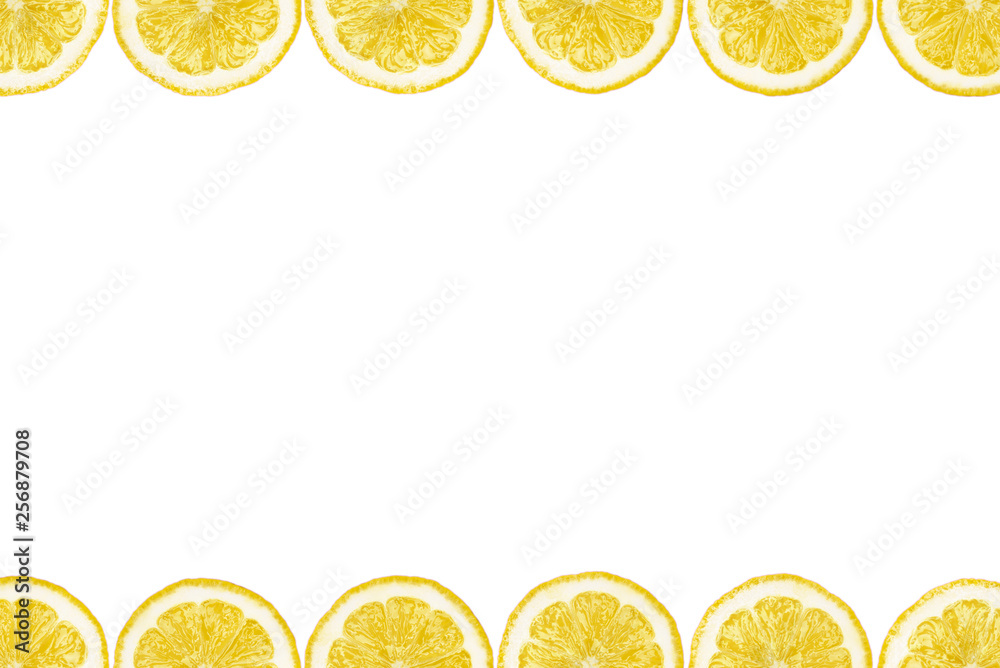 Pattern made from fresh lemon slices on a white background with copy space in the middle. Overhead view, flatlay. Fruit background.