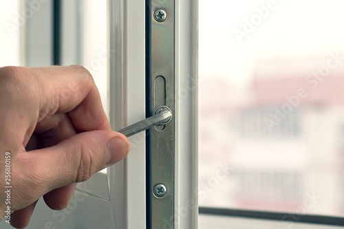 Workman adjusts the operation of the plastic window.