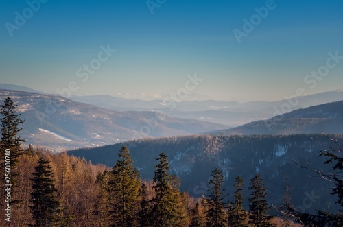 Beautiful winter mountain landscape. Sunny day on the trail in the Polish mountains. © shadowmoon30