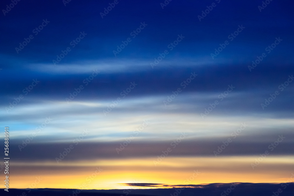 Sunset transparent blue clouds in the dark sky. Background from dramatic cloudy sky.