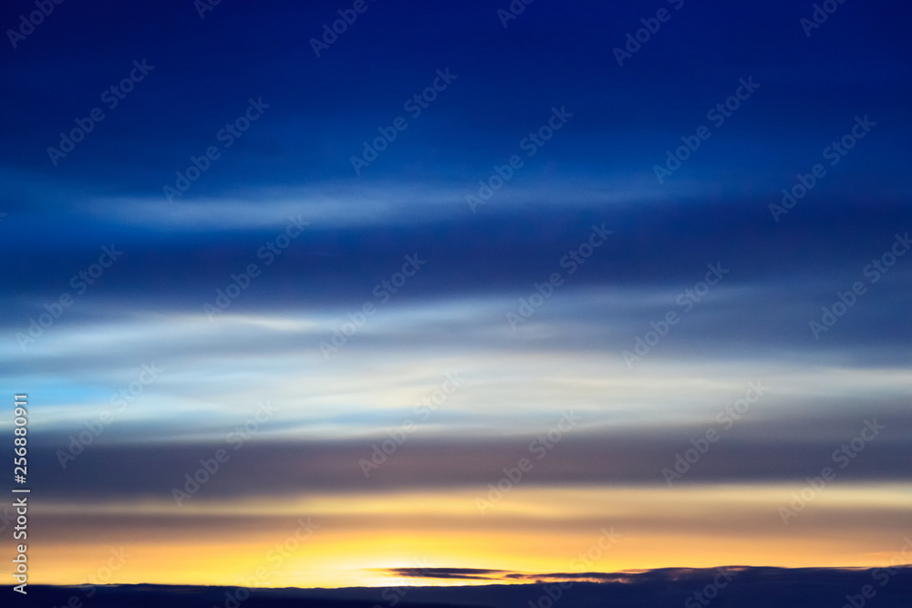 Fototapeta premium Sunset transparent blue clouds in the dark sky. Background from dramatic cloudy sky.
