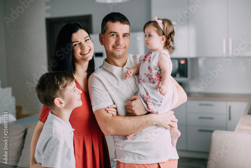 Portrait of young happy family at home