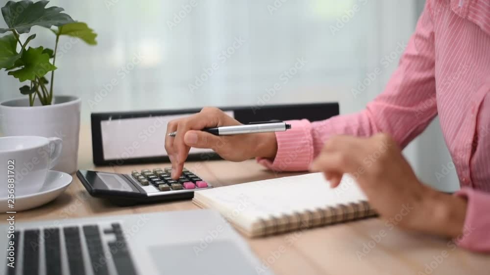 Home finances, investment, economy, saving money or insurance concept. Hands closeup. Close up of female accountant or banker making calculations. 