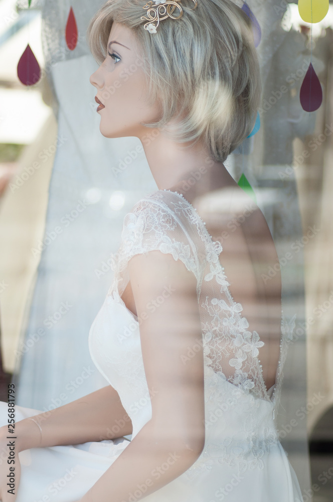 closeup of wedding dress on mannequin in fashion store showroom closeup of wedding dress on mannequin in fashion store showroom