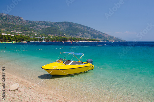 Yellow boat near cape Zlatni Rat of Brac Island, Adriatic Sea, Croatia