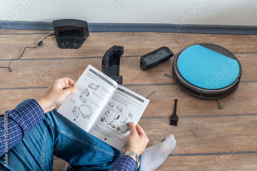 Reading the user guide for robot vacuum cleaner photo
