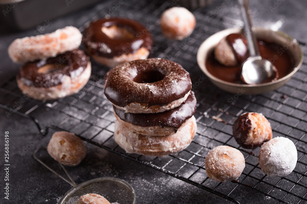Homemade donuts with sugar and cinnamon on a wooden background. Rustic style. Homemade donuts with sugar and cinnamon on a wooden background. Rustic style.