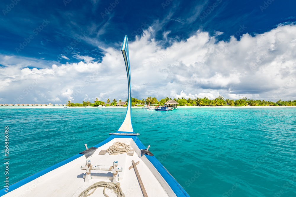 Maldives islands concept, Dhoni boat, traditional wooden boat of Maldives with amazing blue sea and blue sky. Exotic travel or vacation background template