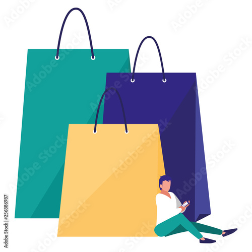 young man using smartphone with shopping bag