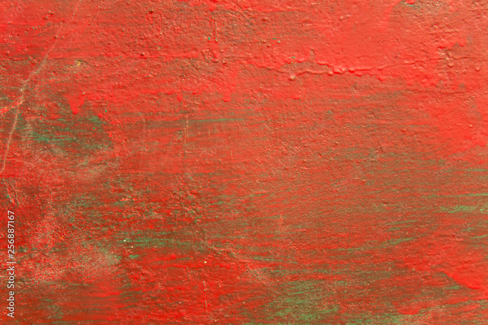 old shabby green blue wall with stains of red paint, cracks and scratches. rough surface texture