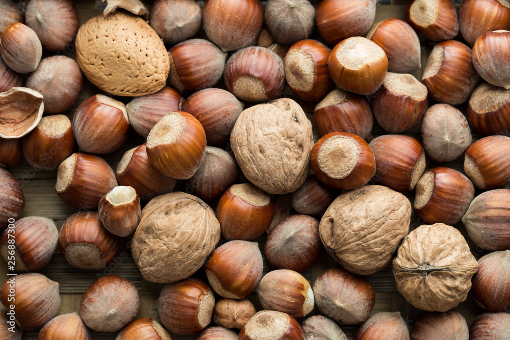 Scattered nut on table top view. Nut assortment flat lay. Nut texture. Nut package Scattered nut on table top view. Nut assortment flat lay. Nut texture. Nut package