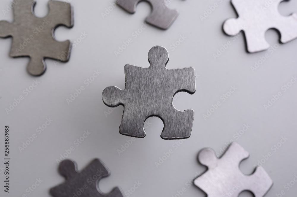 Obraz premium metal puzzle on a white background