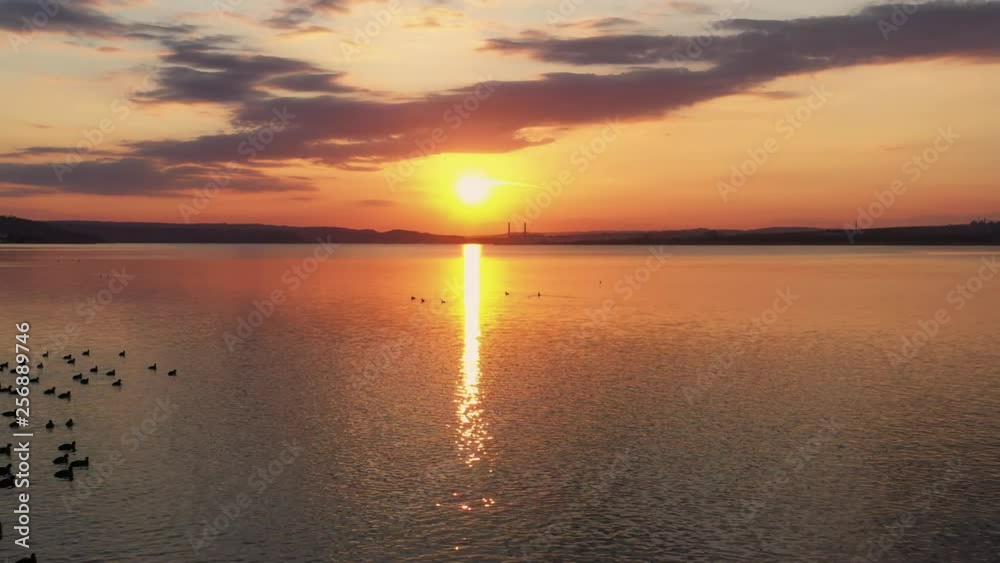 Sea in light of golden sunset of day aerial view of drone slide above. Small waves on sea. Sunny sunset over the sea. Sun way. The sky with clouds. Horizon. Nature Sea in light of golden sunset of day aerial view of drone slide above. Small waves on sea. Sunny sunset over the sea. Sun way. The sky with clouds. Horizon. Nature