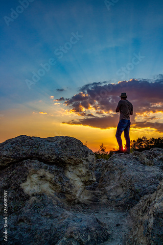 Rear view of unrecognizable male photographer admiring the sunset over the Stone Mushrooms near Beli Plast village  Kardzhali Municipality  Bulgaria