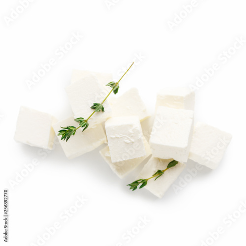 Pile of greek cheese cubes on white