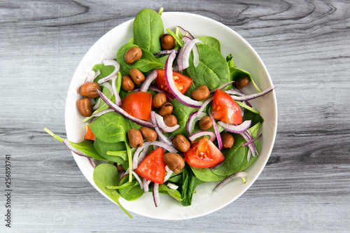 healthy dinner salad bowl of garden greens and bean protein
