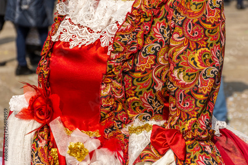 Italy, Venice, 2919 carnival, typical masks, beautiful clothes, posing for photographers and tourists. Details of the dress and objects.