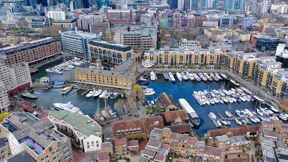 Aerial drone bird's eye view photo of famous St Katharine Docks Marina in City of London near iconic Tower bridge, London, United Kingdom