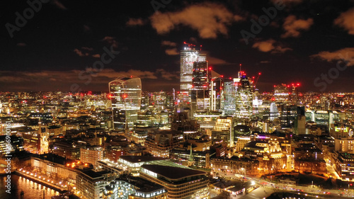 Aerial drone panoramic night shot of iconic financial district over river Thames in City of London, United Kingdom