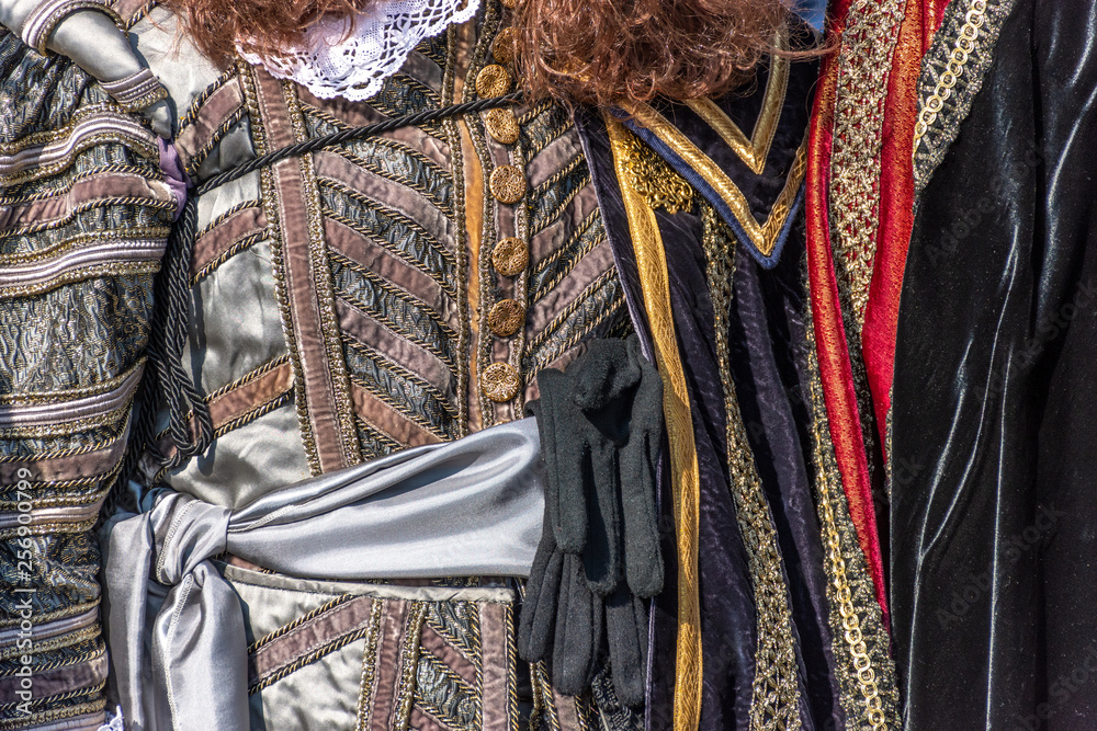 Italy, Venice, 2919 carnival, typical masks, beautiful clothes, posing for photographers and tourists. Details of the dress and objects.