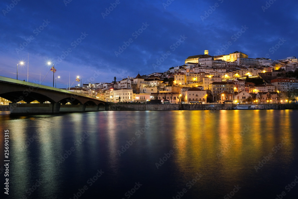 March 15, 2019 Coimbra city in Portugal Night panorama with the illumination of  with the bridge over the Mondega River