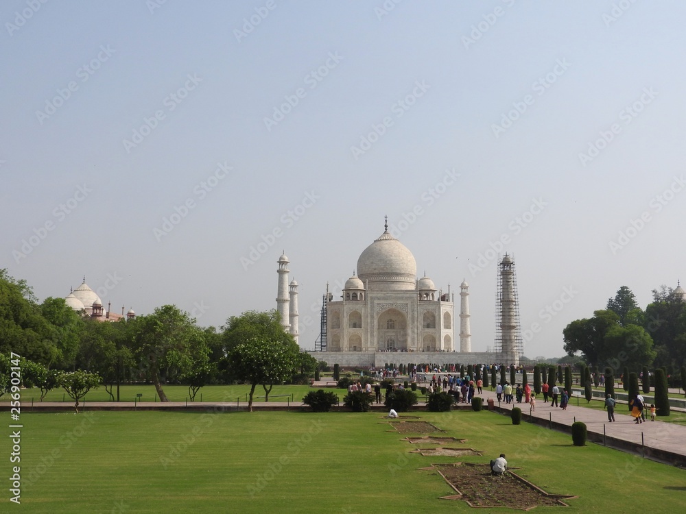 The girl in the hat from behind looks at the Taj Mahal Mausoleum, a symbol of love, white marble on the southern Bank of the Yamuna river in the Indian city of Agra, Uttar Pradesh.