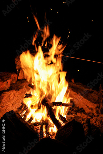 Fire with sparks on a black background. Flame. Bonfire Summer night